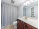Bathroom with wooden vanity, shower/tub combo with shower curtain and big mirror at 13 Ivy Ne Sq, Atlanta, GA 30342