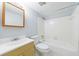Bright bathroom with white tiles, wood frame mirror, and modern fixtures at 13 Ivy Ne Sq, Atlanta, GA 30342