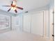Bedroom with a ceiling fan and natural light from the large window at 13 Ivy Ne Sq, Atlanta, GA 30342