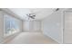 Bright bedroom featuring plush carpet, ceiling fan, and a large window with natural light at 13 Ivy Ne Sq, Atlanta, GA 30342