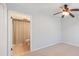 Bedroom with ceiling fan, plush carpet, and an ensuite bathroom at 13 Ivy Ne Sq, Atlanta, GA 30342