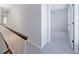 Upstairs hallway with plush carpet and views into a bright bedroom at 13 Ivy Ne Sq, Atlanta, GA 30342
