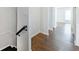 Upstairs hallway with hardwood floors leading to a bright bedroom at 13 Ivy Ne Sq, Atlanta, GA 30342