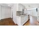 Modern kitchen featuring white cabinets, granite countertops, stainless steel appliances, and wood floors at 13 Ivy Ne Sq, Atlanta, GA 30342