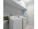 Bright laundry area features tile floor and a newer white washer and dryer at 13 Ivy Ne Sq, Atlanta, GA 30342