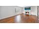 Bright living room featuring hardwood floors, fireplace with a stone surround and a large window at 13 Ivy Ne Sq, Atlanta, GA 30342