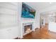 Living room showcasing fireplace with built-in shelves, mounted tv, and adjacent kitchen at 13 Ivy Ne Sq, Atlanta, GA 30342