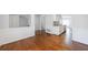 Spacious living room with wood floors flowing into the kitchen with white cabinets at 13 Ivy Ne Sq, Atlanta, GA 30342