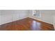 Spacious living room featuring gleaming wood floors, wainscoting, and natural light at 13 Ivy Ne Sq, Atlanta, GA 30342