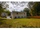 Spacious backyard with painted brick house, wood fence, stone paver patio, and lush greenery at 4395 Woodland Brook Se Dr, Atlanta, GA 30339
