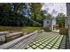 Backyard with stone paver patio, retaining wall, and view of painted brick house at 4395 Woodland Brook Se Dr, Atlanta, GA 30339