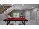 Basement area with a pool table, bar seating, and staircase at 4395 Woodland Brook Se Dr, Atlanta, GA 30339