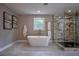 Spa bathroom features a soaking tub, frameless glass shower, and modern finishes at 4395 Woodland Brook Se Dr, Atlanta, GA 30339