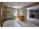 This stunning bathroom features a glass shower and a soaking tub, all with gold hardware at 4395 Woodland Brook Se Dr, Atlanta, GA 30339