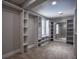 Spacious walk-in closet with custom shelving, drawers, and ample storage space at 4395 Woodland Brook Se Dr, Atlanta, GA 30339
