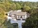 Home's front exterior featuring manicured lawn and landscaping at 4395 Woodland Brook Se Dr, Atlanta, GA 30339