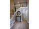 Welcoming foyer with a wood floor, a staircase with metal railings, and a modern console table at 4395 Woodland Brook Se Dr, Atlanta, GA 30339