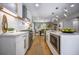 Open kitchen with quartz countertops, stainless steel appliances, and view to dining area at 4395 Woodland Brook Se Dr, Atlanta, GA 30339