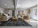 A stylish living room featuring modern furniture, a sleek TV, and a sunlit ambiance with outside access at 4395 Woodland Brook Se Dr, Atlanta, GA 30339