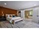 Main bedroom features a wood accent wall, ensuite bathroom and a soft, neutral color palette at 4395 Woodland Brook Se Dr, Atlanta, GA 30339