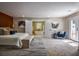 Bright main bedroom features ensuite bathroom, bench seat and bright, airy color palette at 4395 Woodland Brook Se Dr, Atlanta, GA 30339