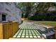 An outdoor patio showcasing stone pavers with grass, leading to the house and backyard at 4395 Woodland Brook Se Dr, Atlanta, GA 30339
