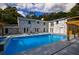 Backyard featuring a pool, patio area, and painted brick house with natural light at 4395 Woodland Brook Se Dr, Atlanta, GA 30339