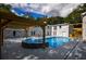 Backyard pool and spa area features a pergola, patio and painted brick home exterior at 4395 Woodland Brook Se Dr, Atlanta, GA 30339