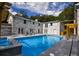 A backyard with a pool, patio area, and painted brick exterior at 4395 Woodland Brook Se Dr, Atlanta, GA 30339