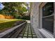 A landscaped backyard featuring a stone paver path along the side of the painted brick house at 4395 Woodland Brook Se Dr, Atlanta, GA 30339
