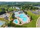 Aerial view of a community pool with a lake and greenery in the background on a beautiful sunny day at 510 Winder Trl, Canton, GA 30114