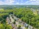 An aerial view shows the homes, tree-lined streets, and wooded areas in the surrounding neighborhood at 510 Winder Trl, Canton, GA 30114