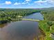 This aerial view shows a picturesque lake surrounded by lush greenery and a scenic causeway at 510 Winder Trl, Canton, GA 30114