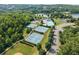 This aerial view highlights community amenities including tennis courts, a pool, and a lake at 510 Winder Trl, Canton, GA 30114