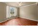 Bright, airy bedroom with laminate floors, neutral walls, a ceiling fan, and a large window at 510 Winder Trl, Canton, GA 30114