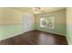 This bedroom features a ceiling fan, window, and hardwood floors at 510 Winder Trl, Canton, GA 30114