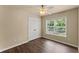 This bedroom features a ceiling fan, window, and hardwood floors at 510 Winder Trl, Canton, GA 30114