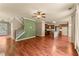 View of an open-concept living room and kitchen featuring hardwood floors, neutral walls, and staircase at 510 Winder Trl, Canton, GA 30114