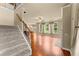 View of an open-concept living room featuring hardwood floors, neutral walls, and staircase at 510 Winder Trl, Canton, GA 30114