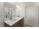 Bathroom featuring double sinks, wood cabinets, quartz counters and a walk-in shower with glass door at 61 N Auburn Landing Pl, Auburn, GA 30011