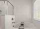 Bright bathroom featuring a soaking tub with a window, a tiled shower with glass door at 61 N Auburn Landing Pl, Auburn, GA 30011