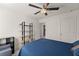 Bedroom featuring a bed, a ceiling fan, shelving unit, and a gray chair at 61 N Auburn Landing Pl, Auburn, GA 30011