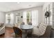 Bright dining area featuring a round table, banquette seating, and natural light from surrounding windows at 61 N Auburn Landing Pl, Auburn, GA 30011
