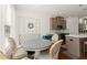 Dining area adjacent to kitchen showcases a round table, banquette seating, and stylish decor at 61 N Auburn Landing Pl, Auburn, GA 30011