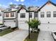 Charming townhome featuring a two-car garage, complemented by green landscaping and a welcoming entrance at 61 N Auburn Landing Pl, Auburn, GA 30011