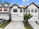 Modern townhome with a two-car garage and stylish design, offering convenience and curb appeal at 61 N Auburn Landing Pl, Auburn, GA 30011