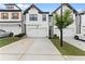 Charming townhome with a two-car garage, concrete driveway, and manicured lawn at 61 N Auburn Landing Pl, Auburn, GA 30011