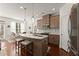 Bright kitchen featuring quartz countertops, stainless steel appliances, and bar stools at 61 N Auburn Landing Pl, Auburn, GA 30011