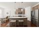 Stylish kitchen with an island, stainless steel appliances, and adjacent dining area at 61 N Auburn Landing Pl, Auburn, GA 30011