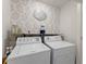 Laundry room with wallpaper, two appliances and a Laundry Room sign at 61 N Auburn Landing Pl, Auburn, GA 30011